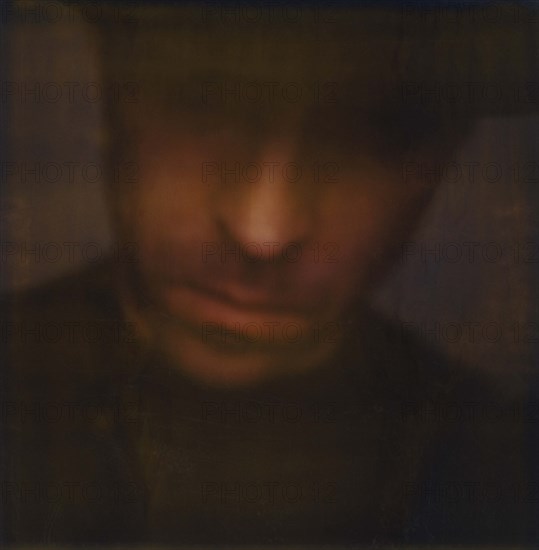 Blurred head and shoulders portrait of mid-adult man