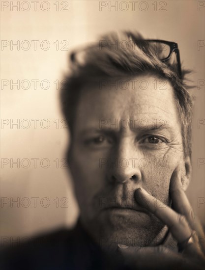 Head and shoulders portrait of contemplative mid-adult man