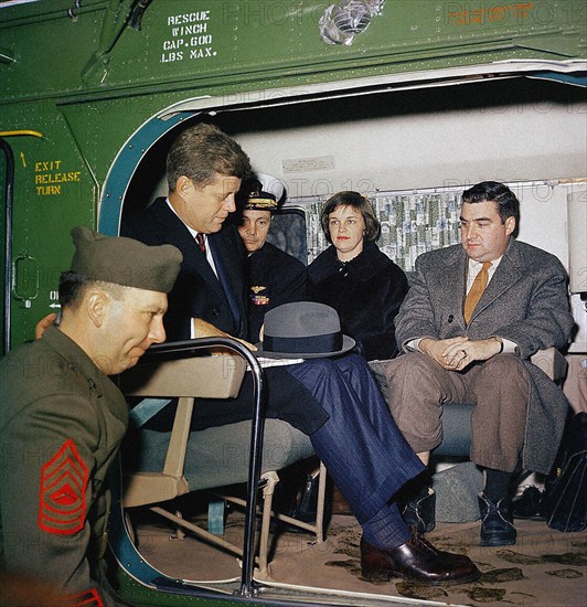 U.S. President John F. Kennedy with Naval Aide to the President Commander Tazewell Shepard, Jr.; Nancy Salinger with husband U.S. Press Secretary Pierre Salinger, wait aboard U.S. Marine Corps helicopter preparing for take off, South Lawn, White House, Washington, D.C., USA, Robert Knudsen, White House Photographs, February 11, 1961