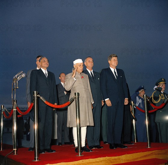 U.S. Ambassador to India John Galbraith (partially hidden), Indian Ambassador to the United States B.K. Nehru, State Department Chief of Protocol Angier Biddle Duke, Indian Prime Minister Jawaharlal Nehru, U.S. Vice President Lyndon B. Johnson, and U.S. President John F. Kennedy, on podium during arrival ceremonies for Prime Minister Nehru, Andrews Air Force Base, Maryland, USA, Robert Knudsen, White House Photographs, November 6, 1961