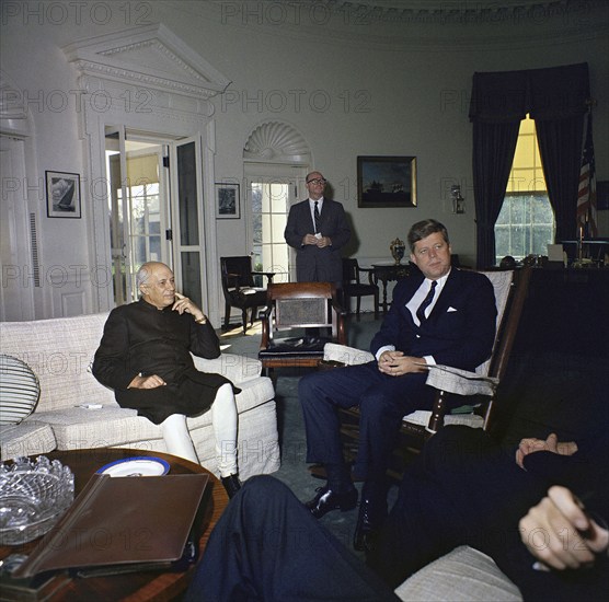 U.S. President John Kennedy (sitting in rocking chair) meeting with Prime Minister of India Jawaharlal Nehru, Special Assistant to the President Dave Powers standing in background,  Oval Office, White House, Washington, D.C., USA, Robert Knudsen, White House Photographs, November 7, 1961