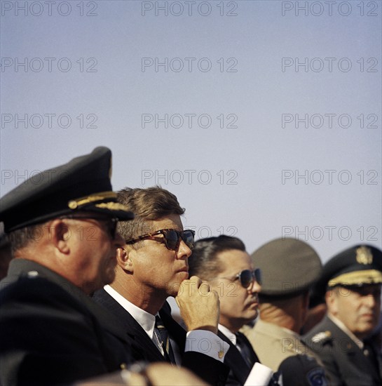 U.S. President John Kennedy sitting between General George H. Decker, Chief of Staff of U.S Army and Elvis Jacob Stahr, Jr., Secretary of the Army, while visiting 82nd Airborne Division, Pope Air Force Base, Fort Bragg, North Carolina, USA, Cecil Stoughton, White House Photographs, October 12, 1961