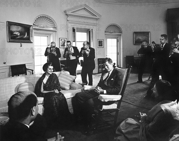 U.S. President John F. Kennedy (in rocking chair) meeting with Indira Gandhi, daughter of Prime Minister Jawaharlal Gandhi of India, Oval Office, White House, Washington, D.C., USA, Abbie Rowe, White House Photographs, March 26, 1962