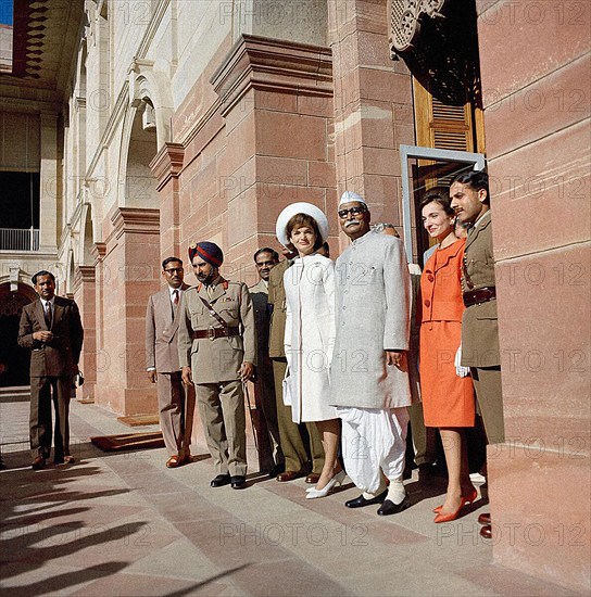 U.S. First Lady Jacqueline Kennedy, President of India Dr. Rajendra Prasad (center) Mrs. Kennedy’s sister, Princess Lee Radziwill of Poland, stand in doorway of Rashtrapati Bhavan, the President’s official residence, New Delhi, India, Cecil Stoughton, White House Photographs, March 12, 1962