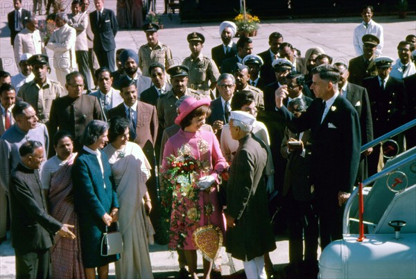 U.S. First Lady Jacqueline Kennedy (center, wearing pink) being greeted by Prime Minister of India, Jawaharlal Nehru, upon her arrival at Palam Airport, Delhi, India, Cecil Stoughton, White House Photographs, March 12, 1962