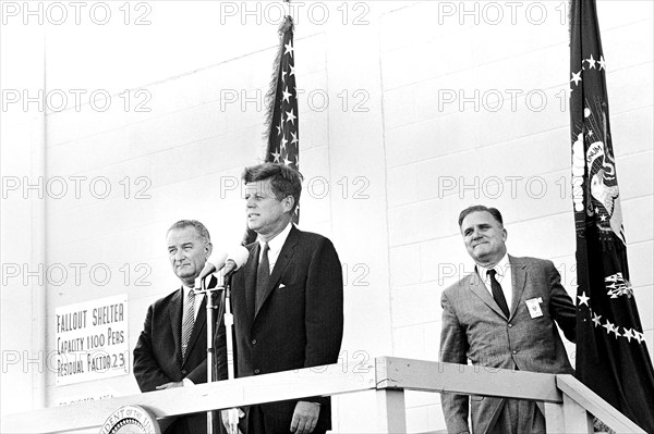 U.S. President John F. Kennedy delivering remarks following tour, with U.S. Vice President Lyndon Johnson (left) and Administrator of NASA Dr. James E. Webb (right) standing behind, Cape Canaveral Air Force Station, Cape Canaveral, Florida, USA, Robert Knudsen, White House Photographs, September 11, 1962