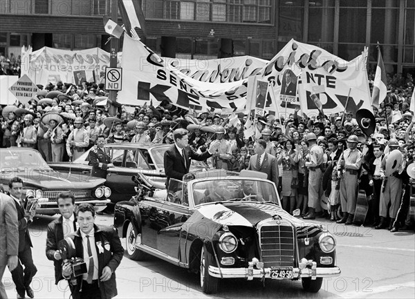 U.S. President John F. Kennedy waving to crowd from convertible car during motorcade to Los Pinos, the official residence of the President of Mexico, Mexico City, Mexico, Robert Knudsen, White House Photographs, June 29, 1962