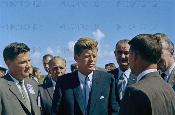 U.S. President John F. Kennedy visiting with astronaut Commander Walter M. Schirra (back to camera), with U.S. Vice President Lyndon Johnson in background, during tour of Mercury-Atlas Launch Complex, Cape Canaveral Air Force Station, Cape Canaveral, Florida, USA, Cecil Stoughton, White House Photographs, September 11, 1962