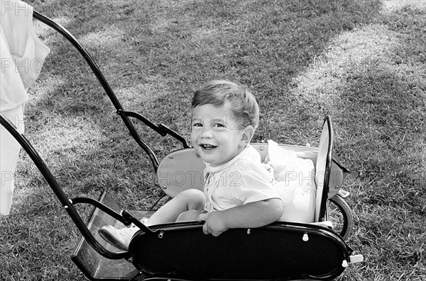 John Kennedy, Jr., sitting in carriage on South Lawn, Washington, D.C., USA, Cecil Stoughton, White House Photographs, May 17, 1962