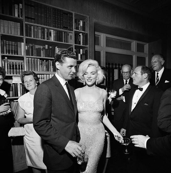 Steven E. Smith, brother-in-law of U.S. President John F. Kennedy, visiting with actress Marilyn Monroe during reception at the residence of Arthur B. Krim and Dr. Mathilde Krim, New York City, New York, USA, Cecil Stoughton, White House Photographs,, May 19, 1962