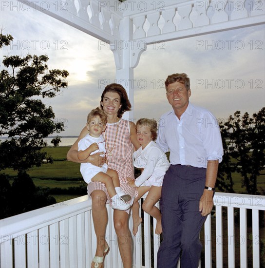 U.S. President John F. Kennedy and U.S. First Lady Jacqueline Kennedy with their children, Caroline Kennedy and John F. Kennedy, Jr., on porch, Hyannis Port, Massachusetts, USA, Cecil Stoughton, White House Photographs, August 4, 1962