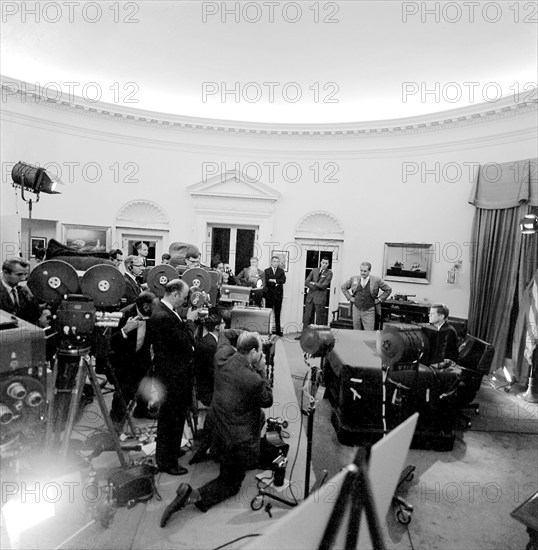 Cameramen film U.S. President John F. Kennedy delivering radio and television address to the nation regarding the Soviet Union’s military presence in Cuba, Oval Office, White House, Washington, D.C., USA, Robert Knudsen, White House Photographs, October 22, 1962