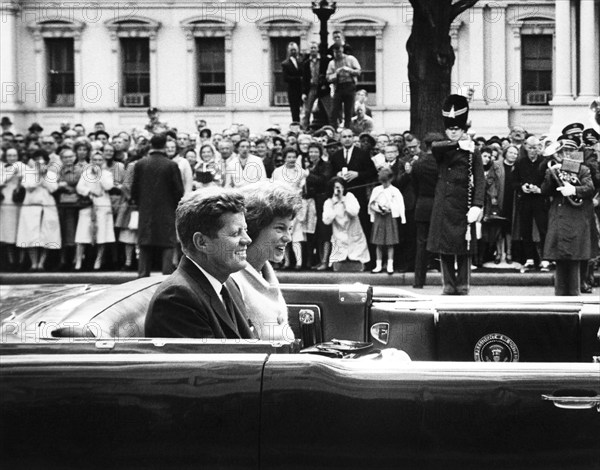 U.S. President John F. Kennedy and Eunice Kennedy Shriver travel in Presidential convertible limousine in motorcade for Grand Duchess Charlotte of Luxembourg, Washington, D.C., USA, Abbie Rowe, White House Photographs, April 30, 1963