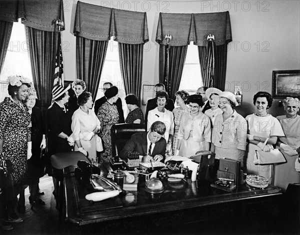 U.S. President John F. Kennedy signing Equal Pay Act, Oval Office, White House, Washington, D.C., USA, Abbie Rowe, White House Photographs, June 10, 1963