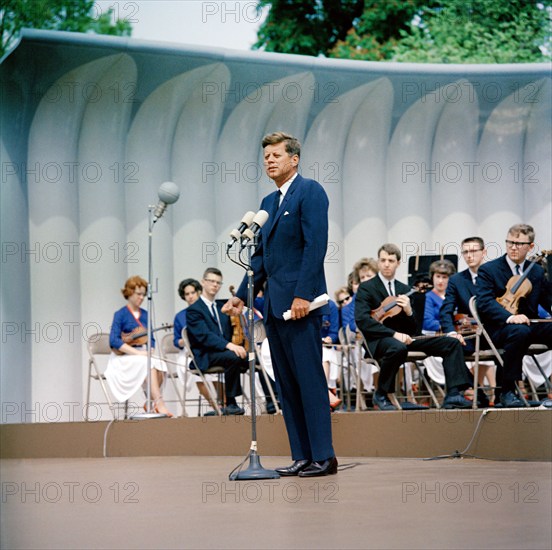 U.S. President John F. Kennedy delivering remarks during performance of Central Kentucky Youth Symphony Orchestra, South Lawn, White House, Washington, D.C., USA, Robert Knudsen, White House Photographs, April 22, 1963