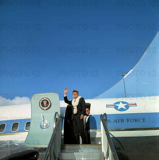 U.S. President John F. Kennedy (wearing flower leis) waving to crowd from stairs of Air Force One before departure from Honolulu International Airport, Honolulu, Hawaii, USA, Robert Knudsen, White House Photographs, June 9, 1963