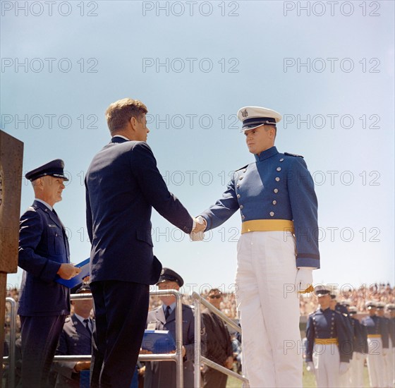 U.S. President John F. Kennedy (left) shaking hands with unidentified cadet during commencement exercises for the fifth graduating class, Falcon Stadium, U.S. Air Force Academy, Colorado Springs, Colorado, USA, Robert Knudsen, White House Photographs, June 5, 1963