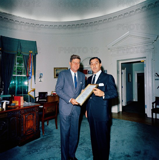 U.S. President John F. Kennedy visiting with American comedian and philanthropist, Danny Thomas (right), both holding Thomas’ Big Brother of the Year Award, Oval Office, White House, Washington, D.C., USA,  Cecil Stoughton, White House Photographs, April 29, 1963