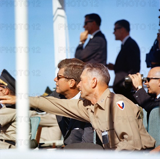 U.S. President John F. Kennedy (wearing sunglasses) and Commanding General J. Frederick Thorlin gesturing towards missile demonstrations, White Sands Missile Range, White Sands, New Mexico, USA, Cecil Stoughton, White House Photographs, June 5, 1963