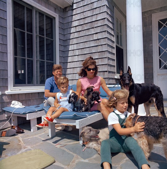 U.S. President John F. Kennedy, U.S. First Lady Jacqueline Kennedy, Caroline Kennedy and John F. Kennedy, Jr., play with their dogs at Brambletyde house, Squaw Island, Hyannis Port, Massachusetts, USA, Cecil Stoughton, White House Photographs, August 14, 1963