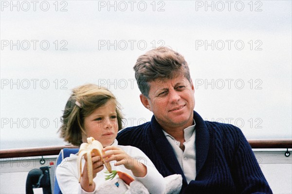 U.S. President John F. Kennedy sitting next to his daughter, Caroline Kennedy, aboard the presidential yacht, “Honey Fitz,” off the coast of Hyannis Port, Massachusetts, USA, Cecil Stoughton, White House Photographs, August 25, 1963