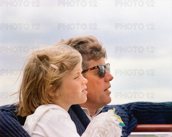 Head and shoulders profile portrait of U.S. President John F. Kennedy sitting next to his daughter, Caroline Kennedy, aboard the Presidential yacht, “Honey Fitz,” off the coast of Hyannis Port, Massachusetts, USA, Cecil Stoughton, White House Photographs, August 25, 1963