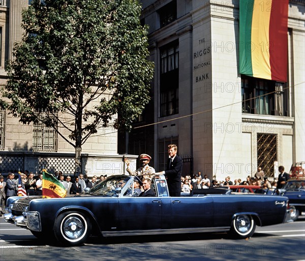 U.S. President John F. Kennedy and Emperor of Ethiopia, Haile Selassie I, waving to crowd along Pennsylvania Avenue in presidential convertible limousine during motorcade from Union Station to Blair House in honor of Emperor Selassie’s arrival, Washington, D.C., USA, Cecil Stoughton, White House Photographs, October 1, 1963