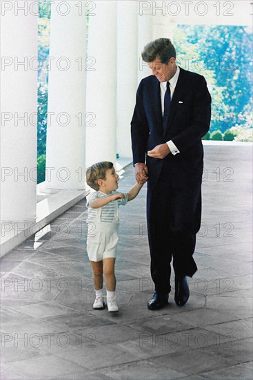 U.S. President John F. Kennedy walking with his son, John F. Kennedy, Jr., along West Wing Colonnade of White House, Washington, D.C., USA, Robert Knudsen, White House Photographs, October 10, 1963