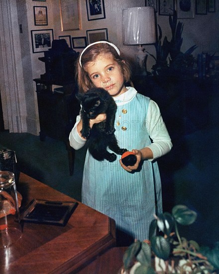 Caroline Kennedy, daughter of U.S. President John F. Kennedy and U.S. First Lady Jacqueline Kennedy, holding a cat in office of U.S. President John F. Kennedy’s personal secretary, Evelyn Lincoln, White House, Washington, D.C., USA, Cecil Stoughton, White House Photographs, October 31, 1963