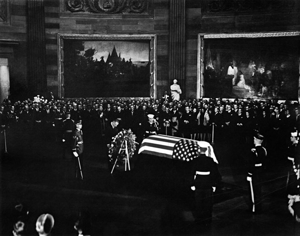 U.S. President Lyndon Johnson standing with bowed head at U.S. President John F. Kennedy's flag-draped casket in center of Rotunda, U.S. Capitol Building, Washington, D.C., USA, Abbie Rowe, White House Photographs, November 24, 1963