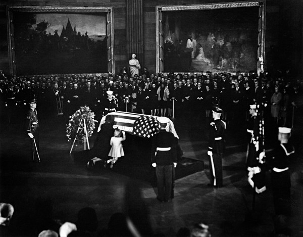 Jacqueline Kennedy and daughter Caroline Kennedy kneel and kiss U.S. President John F. Kennedy's flag-draped casket in center of Rotunda, U.S. Capitol Building, Washington, D.C., USA, Abbie Rowe, White House Photographs, November 24, 1963