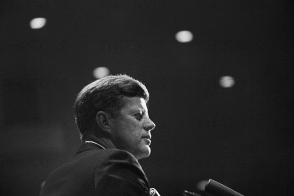 Head and shoulders portrait of U.S. President John F. Kennedy delivering remarks at dinner in honor of Representative Albert Thomas of Texas, Houston Coliseum, Houston, Texas, USA, Cecil Stoughton, White House Photographs, November 21, 1963