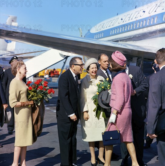 U.S. First Lady Jacqueline Kennedy  being greeted by (l-r): Elizabeth "Dearie" Cabell (with red roses), Dallas Mayor Earle Cabell, U.S. Second Lady Claudia "Lady Bird Johnson and U.S. Vice President Lyndon Johnson (mostly hidden behind Mrs. Kennedy), upon arrival at Love Field, Dallas, Texas, USA, Cecil Stoughton, White House Photographs, November 22, 1963