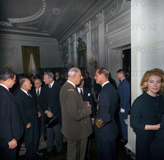 President of France, General Charles de Gaulle, visiting with Prince Philip, Duke of Edinburgh, during a reception at the White House, following the state funeral of U.S. President John F. Kennedy, Washington, D.C., USA, Cecil Stoughton, White House Photographs, November 25, 1963