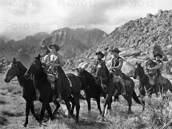 Walter Brennan (left), Virginia Mayo, Kirk Douglas (far right), on-set of the western film, "Along The Great Divide", Warner Bros., 1951