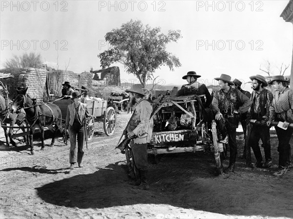 Jean Arthur (standing left with rifle), on-set of the western film, "Arizona", Columbia Pictures, 1940