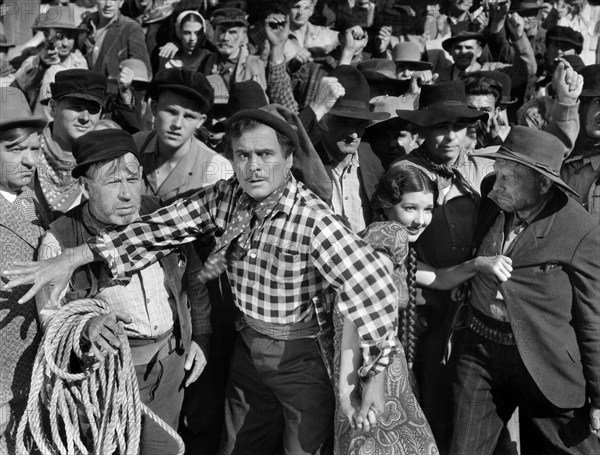 Leo Carrillo (foreground center), Jean Parker (right of Carrillo), on-set of the western film, "The Barrier", Paramount Pictures, 1937