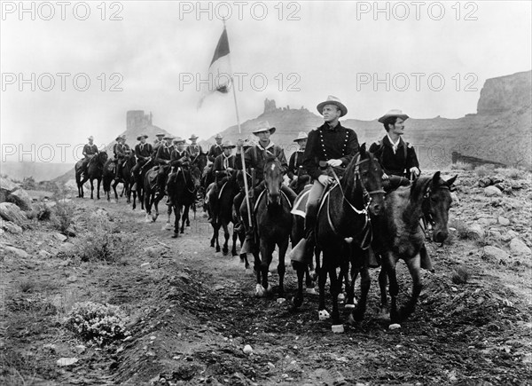 John Lund (foreground, center on horseback), on-set of the western film, "Battle At Apache Pass", Universal International, 1952