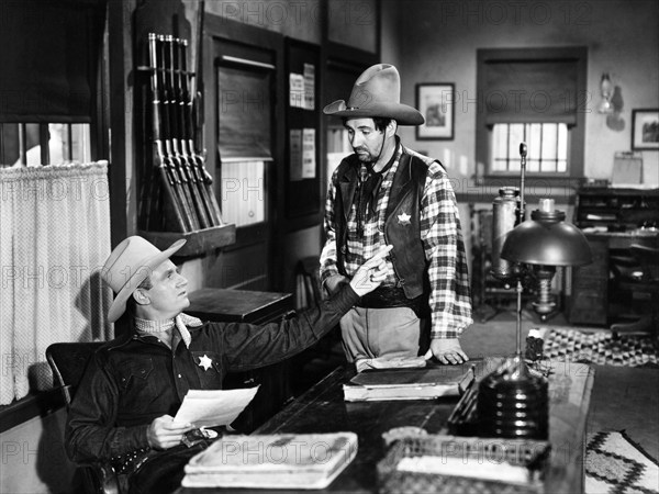 Gene Autry, Pat Buttram, on-set of the western film, "Beyond The Purple Hills", Columbia Pictures, 1950