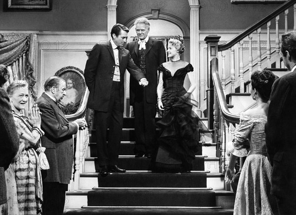 Gregory Peck (on stairs, left), Charles Bickford, (on stairs, center), Carroll Baker (on stairs, right), Jean Simmons (rear-view, right), on-set of the western film, "The Big Country", United Artists, 1958