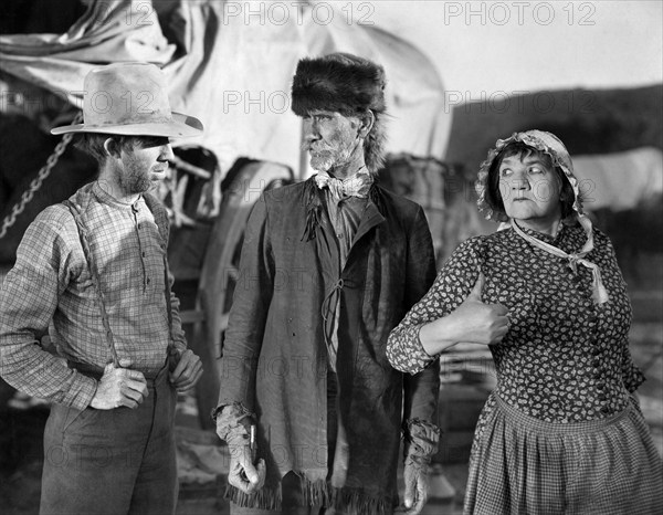 Tully Marshall (center), Louise Carver (right), on-set of the western film, "The Big Trail", Fox Film Corporation, 1930