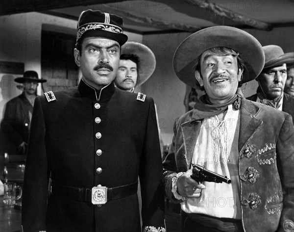 Pedro Armendariz (left), Alfonso Bedoya (right), on-set of the western film, "Border River", Universal Pictures, 1954