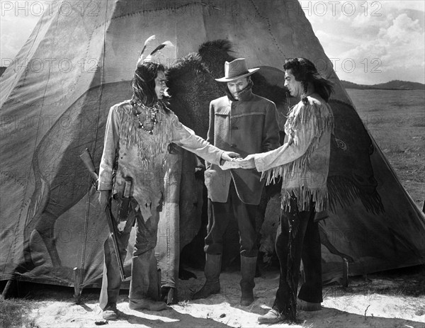 Keith Larson (left), John Lund (center), Victor Mature (right), on-set of the western film, "Chief Crazy Horse", Universal Pictures, 1955