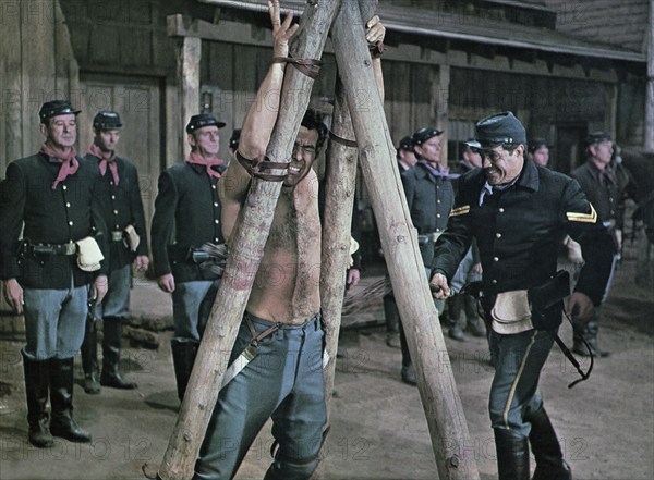 Michael Cole (being flogged), on-set of the western film, "Chuka", Paramount Pictures, 1967