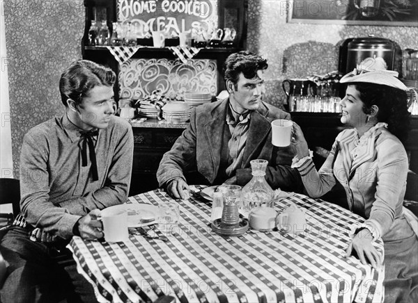 Audie Murphy, James Best, Beverly Tyler, on-set of the western film, "The Cimarron Kid", Universal Pictures, 1952