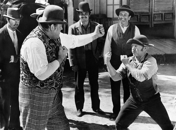 Dan Blocker (left), Mickey Rooney (right), on-set of the western film, "The Cockeyed Cowboys of Calico County", Universal Pictures, 1970