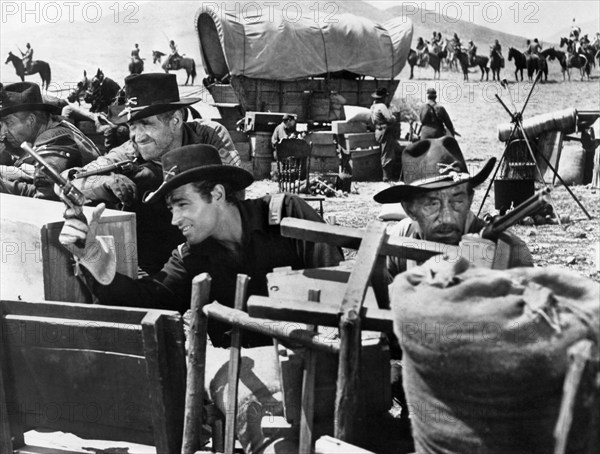 James Whitmore (foreground, left), Guy Madison (foreground, right), on-set of the western film, "The Command", Warner Bros., 1954