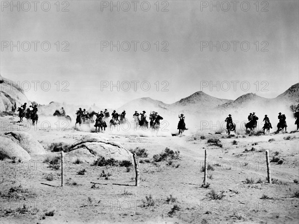 Cowpunchers on horseback, on-set of the western film, "Cow Town", Columbia Pictures, 1950