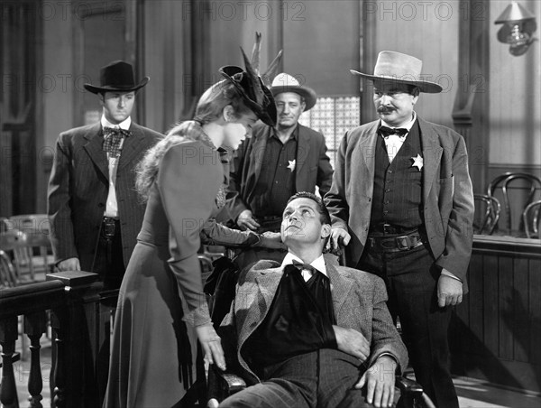 Martha O'Driscoll, Jess Barker (seated), on-set of the western film, "The Daltons Ride Again", Universal Pictures, 1945