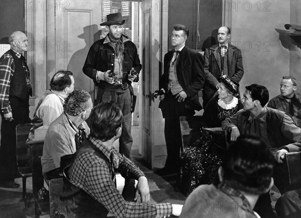 Wayne Morris (standing center holding two handguns), on-set of the western film, "The Desperado", Allied Artists, 1954